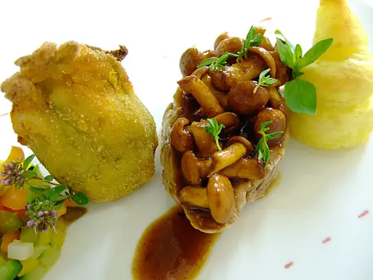 Kalbsmedaillon mit Pfifferlingssauce an sautierten Gemüse und gebackener Zucchiniblüte