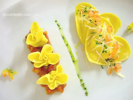 Teigtaschen mit Käsefüllung und Butter abgeschmolzen auf sautierten Tomatenragout