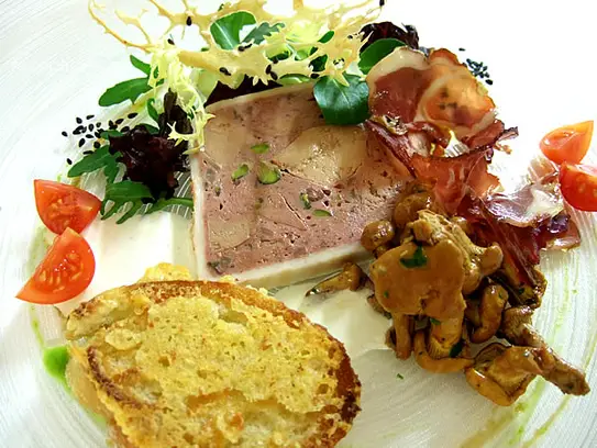 Terrine von der Entenstopfleber mit eingelegten Pfifferlingen und Lammschinken